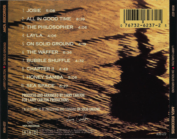 Larry Carlton - On Solid Ground (CD) | Near Mint (NM) Near Mint (NM)-
