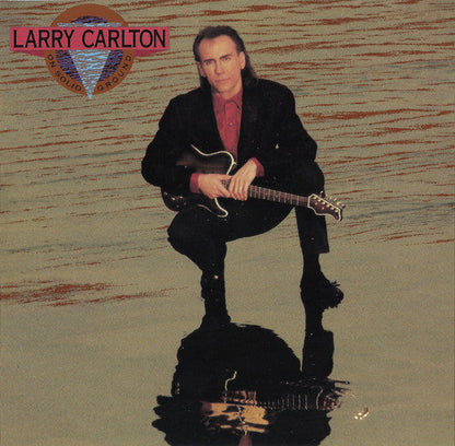 Larry Carlton - On Solid Ground (CD) | Near Mint (NM) Near Mint (NM)-
