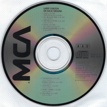 Larry Carlton - On Solid Ground (CD) | Near Mint (NM) Near Mint (NM)-