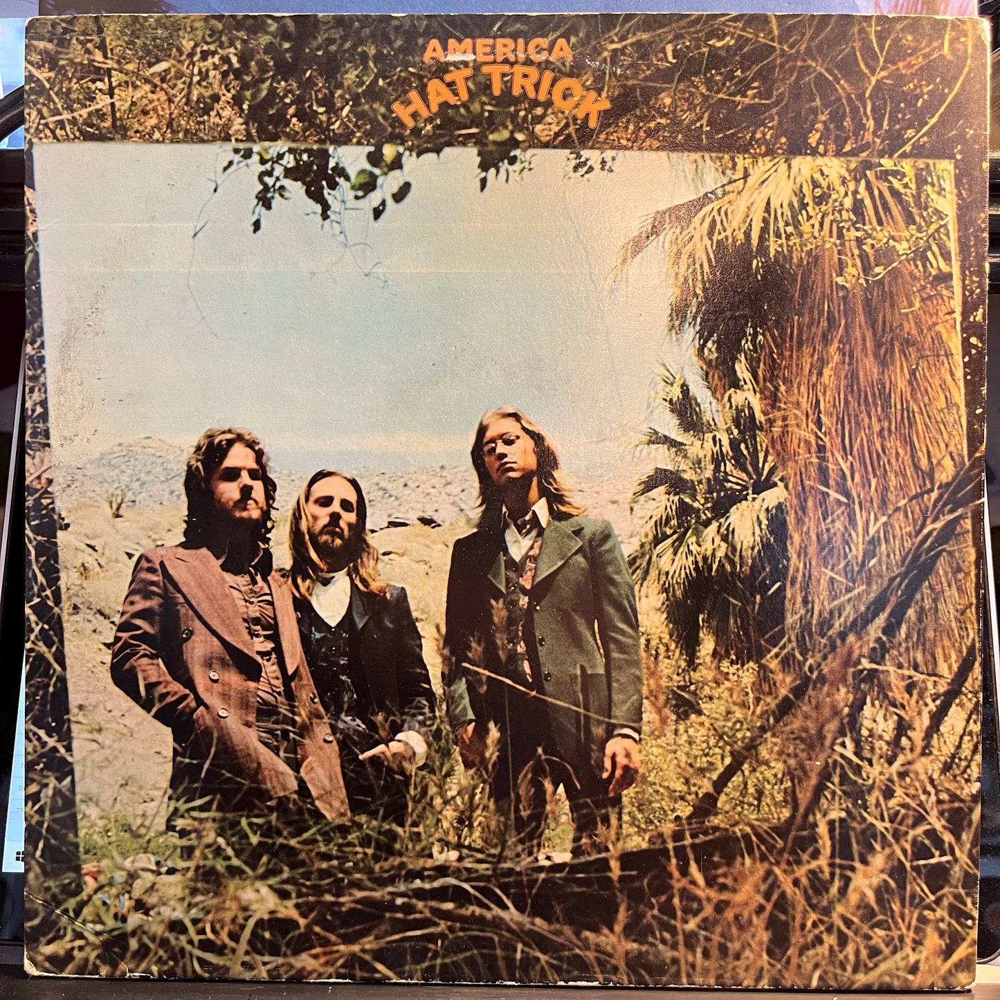 America (2) - Hat Trick (VINYL) | Near Mint (NM) Excellent (EX)-