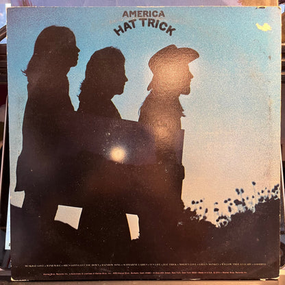 America (2) - Hat Trick (VINYL) | Near Mint (NM) Excellent (EX)-